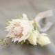 White boutonnieres for grooms on their wedding