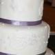 Three Tier Cream And Purple Wedding Cake