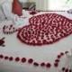 Romantic white bed decorated with red roses