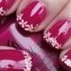 Red nail art with white daisies