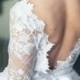 Low back white wedding dress with a bow