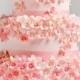 Multi tier pink wedding cake with tiny flowers