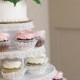 White wedding cake and cupcake decorated with pink roses