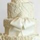 Five-layered Wedding Cake with a white colored bow.