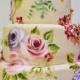 Floral cake decorated with two birds on the top.