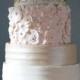 Three tier wedding cake with golden and pink flowers
