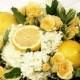 Bouquet with lemons and yellow-colored roses.