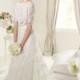 An elegant white-colored wedding dress with the glamorous bun.
