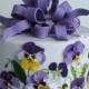 Wedding cakes with pansies and edible bow.