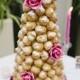 Pretty Croquenbouche wedding cake with pink roses