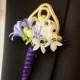 The Groom's Boutonniere Features Small, Delicate Blooms Wrapped In Purple Velvet And Adorned With Berries And A Gold Crest.