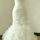 Ivory fit and flare organza wedding dress with sweetheart neckline and handmade flowers