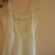 Classy vintage 50s white nylon full slip dress with lace and pleats.Made by Barbizon.Size 6-8
