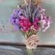 Simple dried flower bridal bouquet in shades of Lavender and rose with burlap rose.