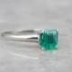 Contemporary Emerald Solitaire Engagement Ring in Platinum D11U1L-P