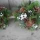 Bridal bouquet made with fresh evergreens, Rose Hips and pine cones with birch handle. For your winter woodland natural wedding.