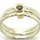 Black diamond ring set in gold stacking hammered silver bands