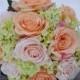 Coral and pink rose with green hydrangea wedding bouquet made of silk roses.