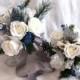 Silver white and blue winter wedding bouquet and boutonniere roses silver glitter pine, green pine, and crystal gems