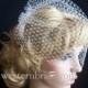 Ivory birdcage veil 12" goes til the pick of the nose. with swarovski crystals on the edge.