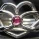 Heart shaped puzzle ring with a pink Tourmaline in sterling silver