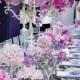Tall Silver Topiaries Are Lush With Pink Roses And Vibrant Orchids, Complimenting This Feminine Wedding Color Scheme.