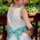 Short linen dress with fabric flowers. Flower girl dress for a beach wedding. White linen sleeveless girl dress.