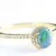 Engagement ring Black opal and diamond halo in 10 carat yellow gold for her