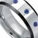 Men's 0.21ct Blue Sapphire Gemstone 3-Stone Wedding Band, September Birthstone Ring, Black IP Edge High Polish Tungsten Carbide Ring TS2182