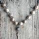 Grey pearl necklace with crystal mesh gunmetal ball and cross with crystals as pendant