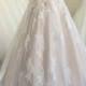 Beautiful sheer tulle bateau neck champagne colored wedding dress
