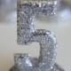 Silver Glittered Table Numbers on Stands can be done in various colors.