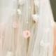 The Flora Veil-a flower veil created with cream and blush pink cascading flowers down soft ivory tulle