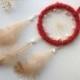 Small red dreamcatcher with white beads and feathers