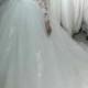 Beautiful long sleeved tulle lace appliqued wedding dress