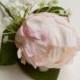 Blush pink silk wedding buttonhole / boutineer. Made from an artificial peony, a gypsophilia cluster and simple greenery.