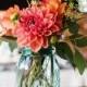 Mason Jars Filled In With Colourful Flowers As Wedding Centerpieces