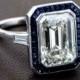 A Gorgeous Emerald Cut Diamond Surrounded By A Halo Of Ceylon Sapphires And Set In A Beautiful Platinum Mounting. Such A Wonderful Antique Engageme… 