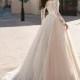 Lace wedding dress with corset an off-shoulder and long lace sleeves, transparent back with buttons, light beige tulle skirt with lace