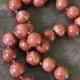 Round, spere shaped vintage red   jasper with gold tone lock