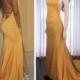 Gold prom dress with open back, mermaid skirt and a train