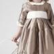 Flower girl dresses. Girls dressed in silk taupe. Decorations in ivory. Square neckline with three quarter sleeves.