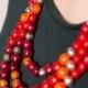 Red, purple, orange wooden beaded necklaces for women. Multicolor necklace in three strands.