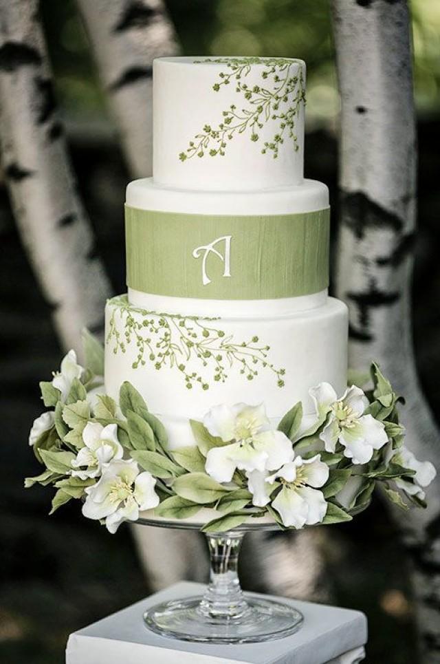 This White Wedding Cake With Green Floral Designs Is A