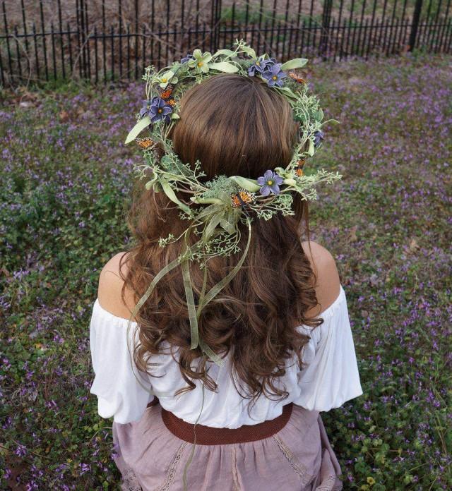 Elaborate flower crown with purple and green flowers, moss and butterflies
