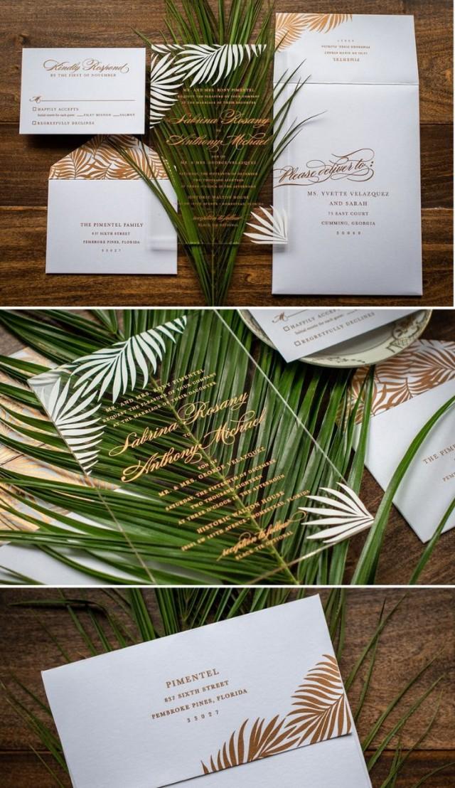 A Crystal Clear Acrylic Wedding Invitation Designed With Pretty Palm Leaves In A Rose Gold And White Color Sche… 