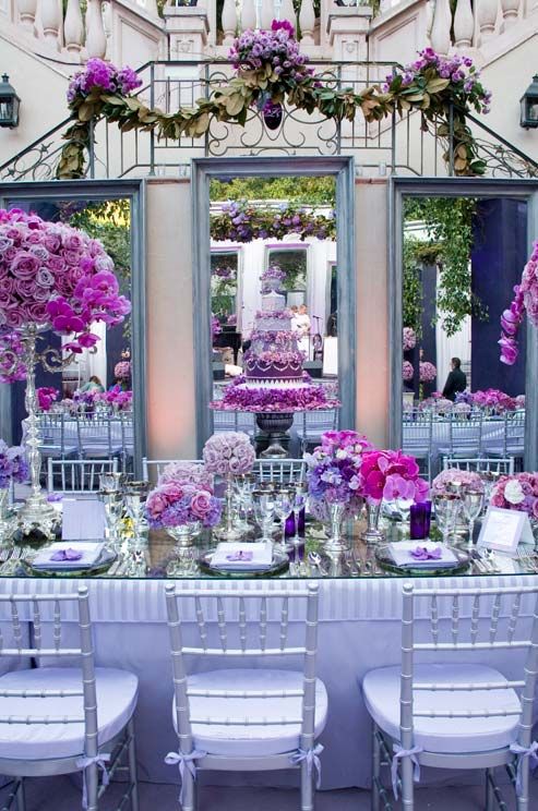 Wedding - Three Large Mirrors Back The Head Table, Showing Off The Purple Cake And Dramatic Floral Arrangements.