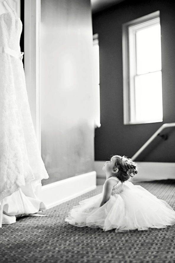 Свадьба - Flower Girl Looking At Wedding Dress.