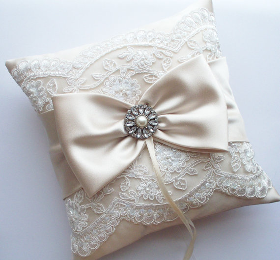 Свадьба - Wedding Ring Pillow in Champagne Satin with Beaded Ivory Alencon Lace, Satin Bow with Rhinestone and Pearl Center - The MELINDA Pillow