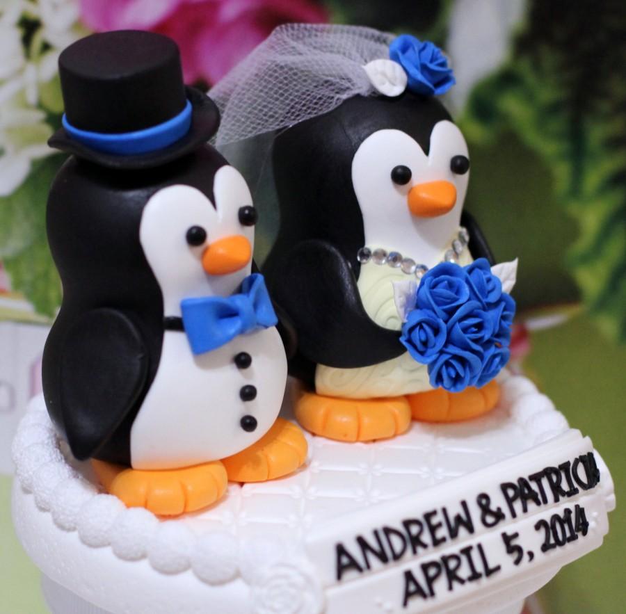 Hochzeit - A penguin couple wedding cake topper. / blue roses